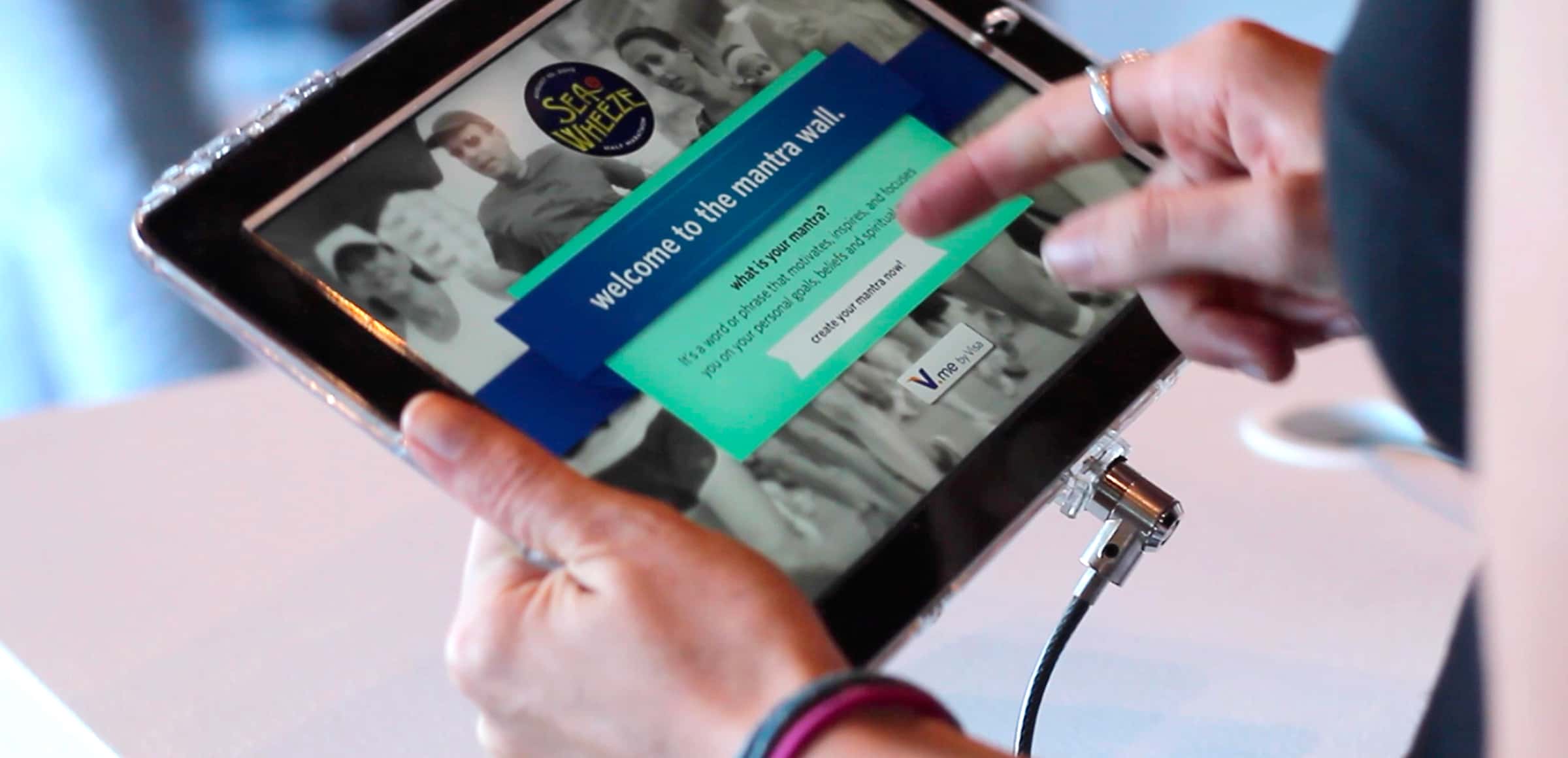 SeaWheeze mantra wall — participant using the iPad app